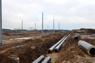 Laying underground storm sewers at a construction site. Groundwater system for new residential buildings in the city. Installation of water main, sanitary sewer, storm drain systems in city.