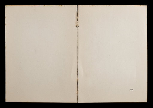 Antique book unfolded showing textured pages isolated on black background.