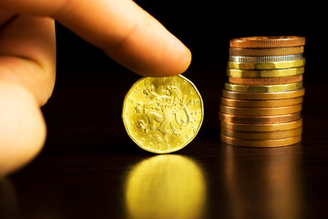 Czech korunas on the table. Yellow coins on the table. Twenty Czech korunas.