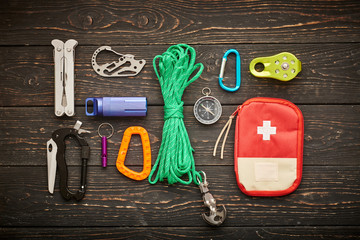 Travel items for hiking tourism still life over wooden background