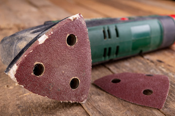 Rotary wood grinder with old sandpaper. Work tool in a carpentry workshop.