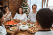 © Odua Images - happy asian family tradition having lunch together on christmas day at home