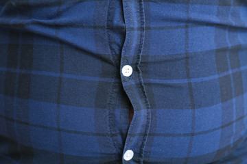 Overweight man in tight clothes, closeup. Weight loss concept