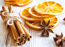 Christmas Spices - Cinnamon Sticks, Star Anise, And Slices Of Dried Orange On Old Wooden Background.