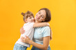 © Pixel-Shot - Portrait of happy mother and daughter on color background