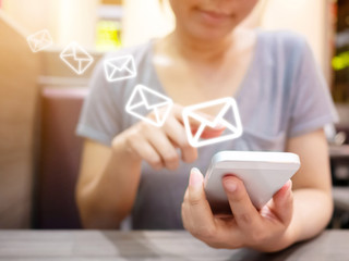 Fototapete - Asian woman hand using smartphone with icon envelope email. Contact us customer service or e-mail marketing concept