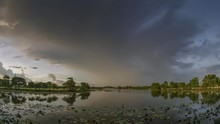 Timelapse Vdo. View Of Dark Clouds Moving Above Lotus Lake With Heavy Raining In Rain Storm Background, Sunset With Rain Storm Above Krajub Reservoir, Ban Pong, Ratchaburi, Thailand.