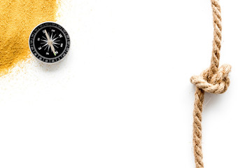 Wall Mural - Goal achievement concept. Compass near rope with knot on white background top view copy space