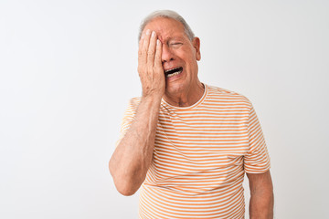 Wall Mural - Senior grey-haired man wearing striped t-shirt standing over isolated white background Yawning tired covering half face, eye and mouth with hand. Face hurts in pain.