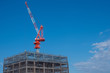 © Grispb - Construction of skyscrapers. Buildings are built using a crane. Construction of high-rise buildings. Construction crane on a background of blue sky. Multi-storey home. Work as a builder.