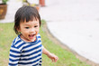 © waridsara - Portrait image of 1-2 years old baby. Happy Asian child girl smiling and running on the road at the park.