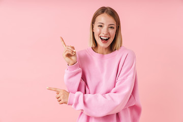 Poster - Portrait of caucasian woman smiling and pointing fingers aside