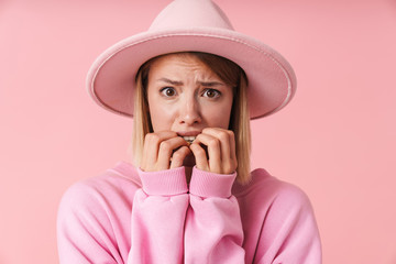 Poster - Portrait of scary woman wearing hat frightening and biting her nails