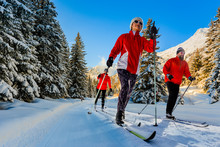 A Family Group Of Cross Country Skiers On A Sunny Winter Morning In Swiss Alps, Thyon Les Collones, Valaise.