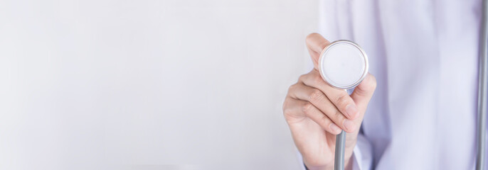 healthcare banner background with doctor hand holding stethoscope over grey background