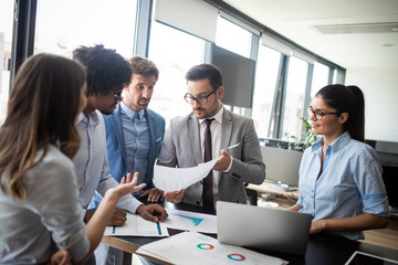 Group of successful business people at work in office