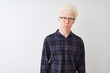 © Krakenimages.com - Young albino blond man wearing casual shirt and glasses over isolated white background puffing cheeks with funny face. Mouth inflated with air, crazy expression.