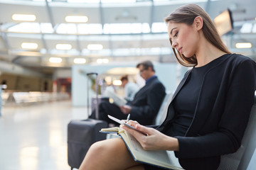 Canvas Print - Businesswoman with appointment book plans her business trip