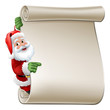© Christos Georghiou - Santa Claus Christmas cartoon character peeking around a scroll sign and pointing at it