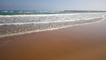 Beautiful Sandy Beach In Morocco. Coming To The Waves And The Azure Sea.
