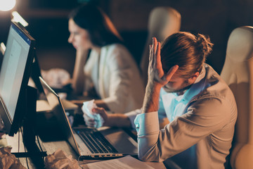 Profile side view of nice attractive intellectual tired hardworking coworkers specialists developing new launch startup solving tech task client support at workplace station dark room
