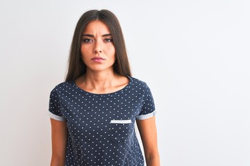 Sticker - Young beautiful woman wearing blue casual t-shirt standing over isolated white background Relaxed with serious expression on face. Simple and natural looking at the camera.