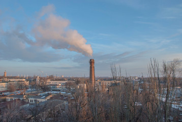 Air pollution in the city. Smoke from the chimney on blue sky background