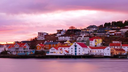 Wall Mural - Kristiansund, Norway. View of city center of Kristiansund, Norway during the cloudy morning at sunrise with colorful sky. Time-lapse of port with historical buildings, zoom in