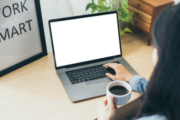 mockup image blank screen computer with blank white background for advertising text,hand man using laptop contact business search information on desk at home office.marketing and creative design