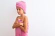 © Krakenimages.com - Beautiful child girl wearing shower towel after bath standing over isolated white background looking to side, relax profile pose with natural face with confident smile.