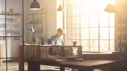 Aufkleber - Thoughtful Young Professional Designer Sits at His Desk and Looks onto Big City out of His Windows, Contemplating Next Steps in Finishing Project. Handsome Professional Working Process in His Studio