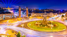 Night View Of Barcelona From The Trade Center Arenas De Barcelona The Central Square (Plaça D'Espanya) With Numerous Traffic Light Trails And  Historical Architecture, Spain