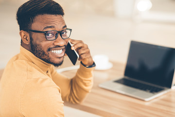 Poster - Happy black man talking on smartphone at office