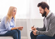© Prostock-studio - Male therapist taking notes, listening to female patient