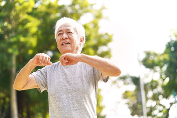 Poster - senior asian man exercising outdoors in park