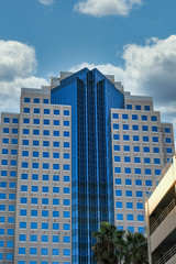 Poster - Modern Stone and Blue Glass Building in the Tropics