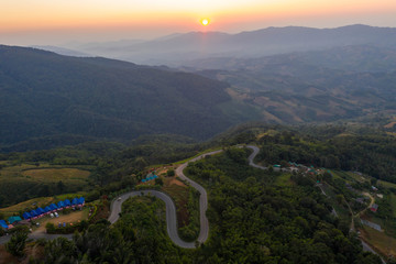 Wall Mural - Aerial view of cars driving curves on the mountains and beautiful roads suitable for holiday travel in chiangrai, thailand