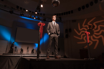 male model showing off business suit during fashion show