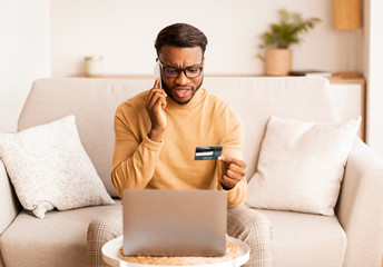 Aufkleber - Man calling to bank solving problems with credit card indoor