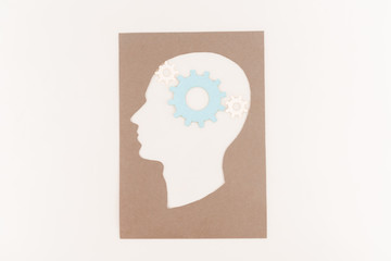 Sticker - top view of human head silhouette with blue gear isolated on white