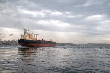 Wall Mural - Cargo ship carrying oil passing through the Bosphorus.