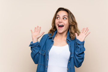 Wall Mural - Young blonde woman over isolated background with surprise facial expression