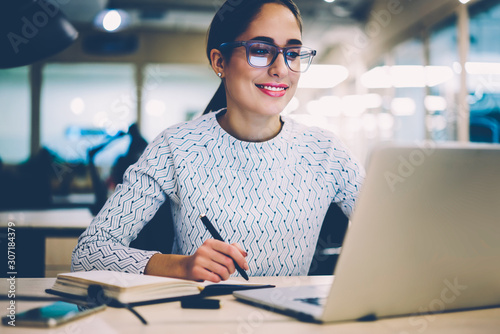 Fotografía Smart young woman satisfied with learning language during online courses using n