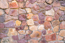 Wall With Random Shape Tiles Made Of Red Granite Rocks.