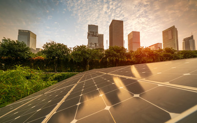 Wall Mural - ecological energy renewable solar panel plant with urban landscape landmarks