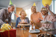© Drazen - Group of cheerful mature people having fun on a birthday party at home.