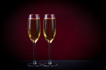 Drink. Two glasses white wine, dark background