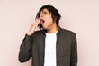 © luismolinero - Young African American man over isolated background yawning and covering wide open mouth with hand