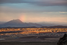 USA, Nevada, Clark County, Henderson. A Sunset, Sun Dog Rainbow, And Frenchman Mountain Over The Sun City Anthem Planned Community Neighborhood South Of Las Vegas.