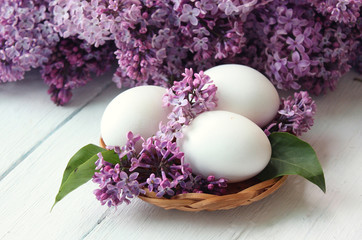  easter eggs and spring flowers in basket